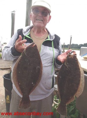 Captain Billy Lake with two flounder pushing 5 pounds.