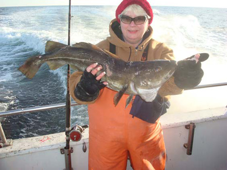 Ginny holds up a fat cod. Caught aboard the Frances Fleet.