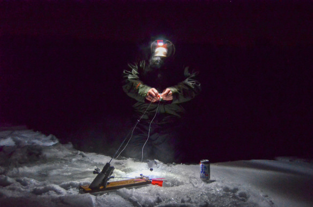 Ryan Bibeau makes sure his shiner is still frisky enough to attract the nighttime crappie. 