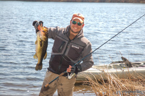 The author with a big bass taken on a crankbait in shallow water.