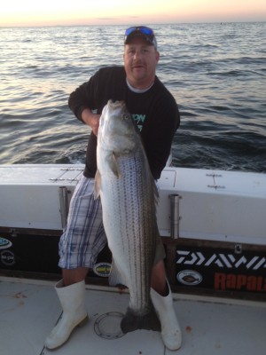 Joe Loretti with a 50-pound striper caught with Captain Eric Kerber of On A Mission Fishing Adventures.