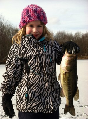 Kailey Demi with a nice largemouth bass she caught while ice fishing in Connecticut on a live shiner.