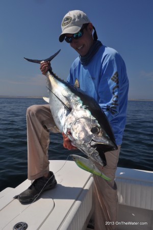 Caption: Posing like Captain Morgan while holding a tuna? That might qualify as "skurgy."