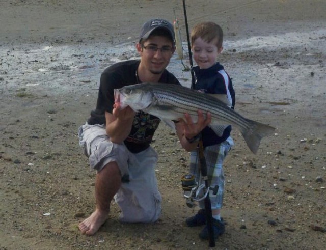 Anthony Laurin of Fairhaven and his little brother Max pose with a 29-inch striper that hit a herring-colored pencil popper. 