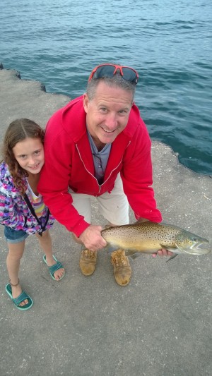 Dr. John Syracuse of Newfane shows off a nice brown caught off the Olcott pier with his 7 year old daughter Sidney.