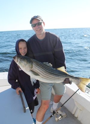 Ralph Folz and his son Jack with one of the 30 bass his party caught that day off Chatham. All fish were in the 30 to 39-inch range.