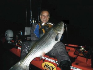 The author with a big bass in the yak. September is a great month for big fish. Photo by Carl Vonnegut.