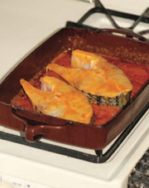 Marinate the steaks in a metal baking dish. You may need to warm up the pan occasionally on the stove, as the butter in the marinade will solidify as it cools.