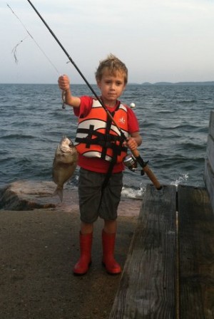 5-year old Will Parker with his first fish ever, caught while fishing on a jetty in Mattapoisett.