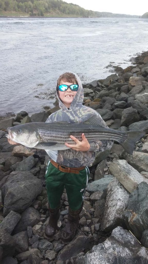 7 year old Jack Balzarini with a 33-inch canal striper.