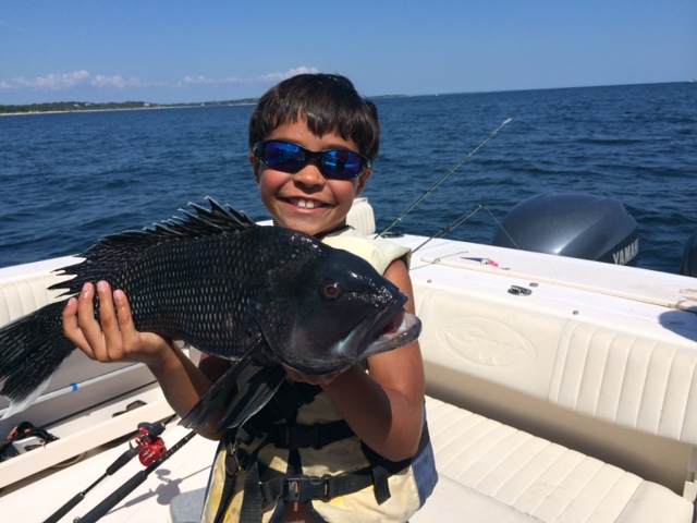 Mason Baez shows off his 23" black sea bass caught on his last day of summer.