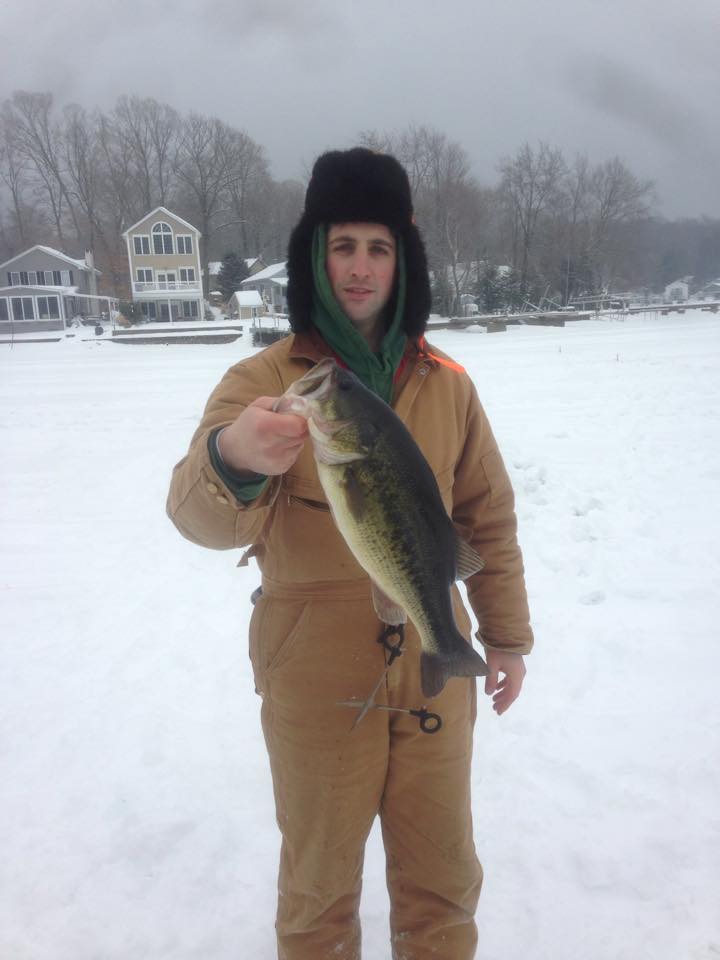 Jeoffrey Langill with his winning bass taken through the ice at Highland Lake.