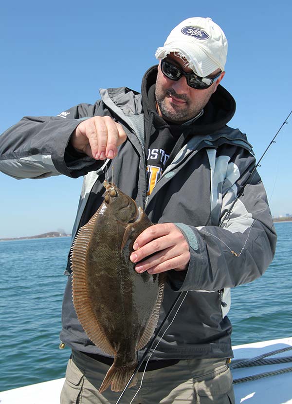 Mark D'Angelo of Winthrop unhooks a healthy flounder