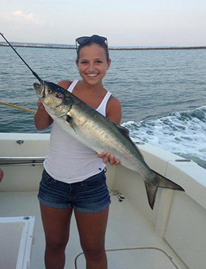 Carly Shomsky with a big bluefish on Rock and Roll Charters