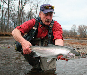 Gary Edwards admires a female steelhead