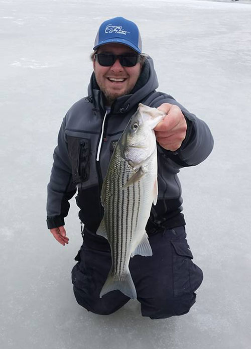 Joe Diorio with a school bass he caught through the ice