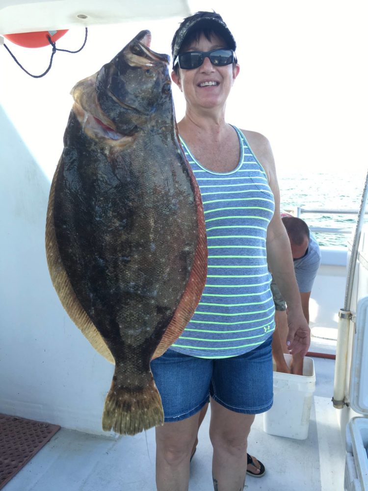 Linda Carrier of Hoboken won the pool money aboard the Gambler on Wednesday with this 9.2-pound fluke. 