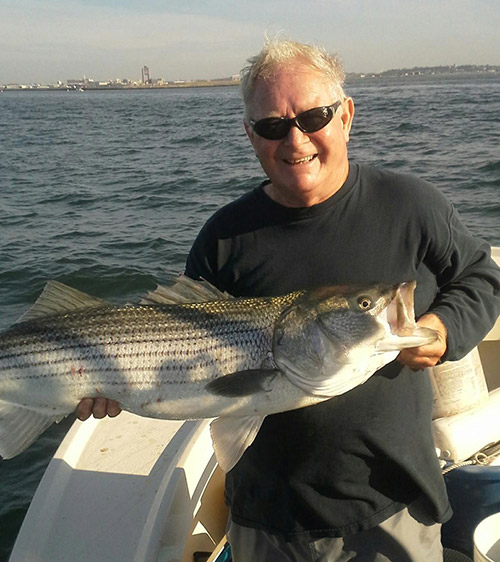 Dave Panarello with a 40" harbor bass full of pogies.