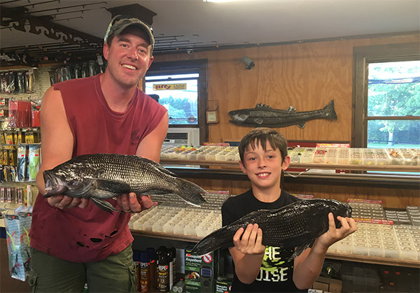 Luke Watson with his dad Tom and the unofficial new New Hampshire black sea bass state record!