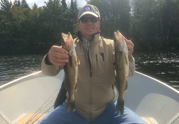 Brantly L with a pair of nice Connecticut River walleyes caught with guide Tim Moore!