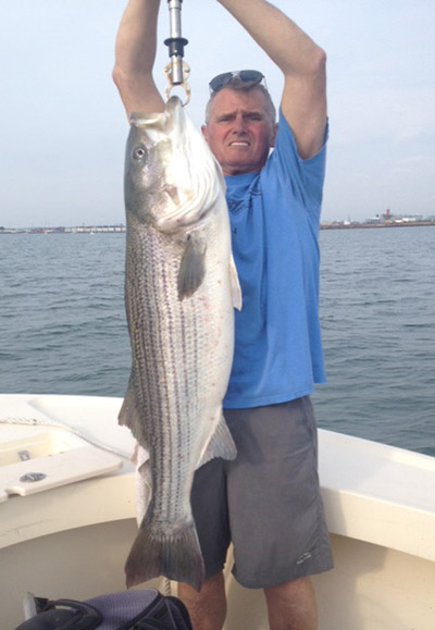 Tom Cronin with a nice harbor striper that he took on a pogy!