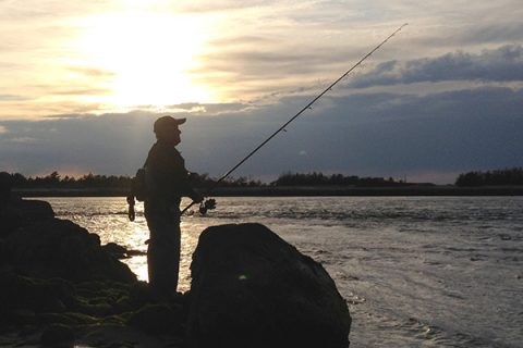 With a running tide and a setting sun, the author begins a productive night of fishing the inlets.