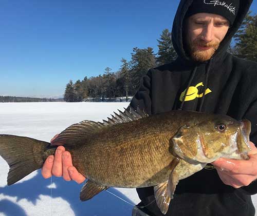 Scottie Bragdon of Dag's with a 4 pound smallie he took from Tripps Lake.