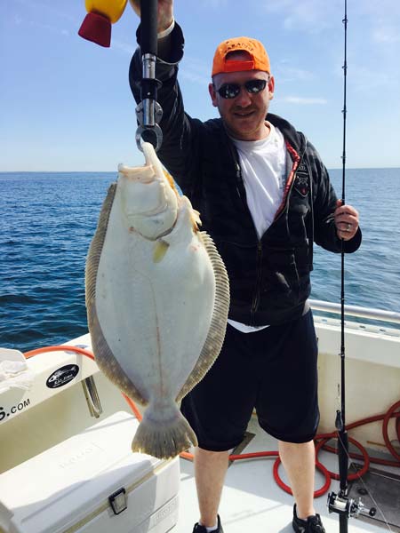 Mike landed this big 7 lb Fluke Captain Stu of Northport Charter's boat
