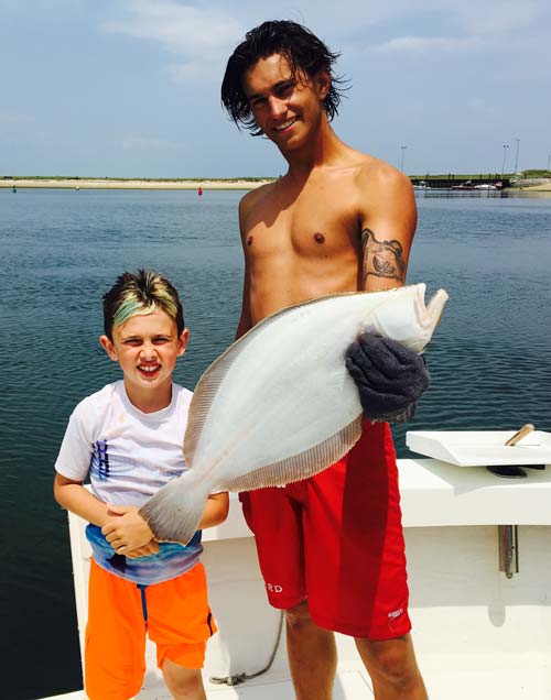 Aboard Northport Charters with Captain Stu, a young angler named Orion nailed his first ever fluke!