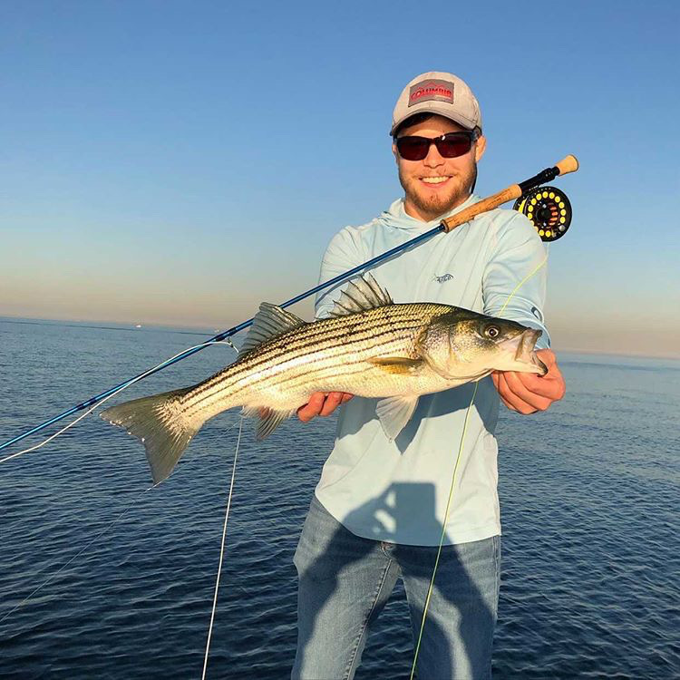 Garrett Lambert with a golden hour bass caught on Capt. Dave Flanagan's boat.