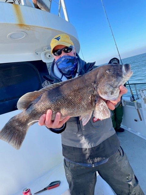 Jerry Rau holding a 9-pound tautog that won the pool on the Osprey.