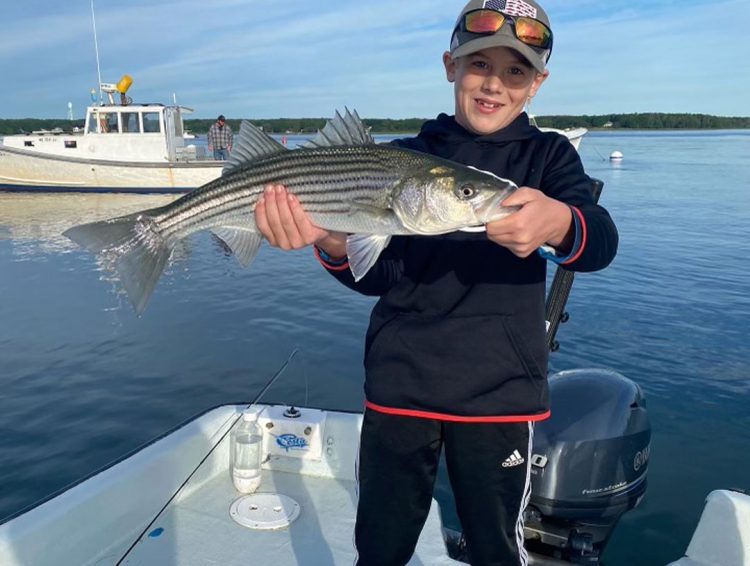 Matt with striper aboard Diamond Pass Charters