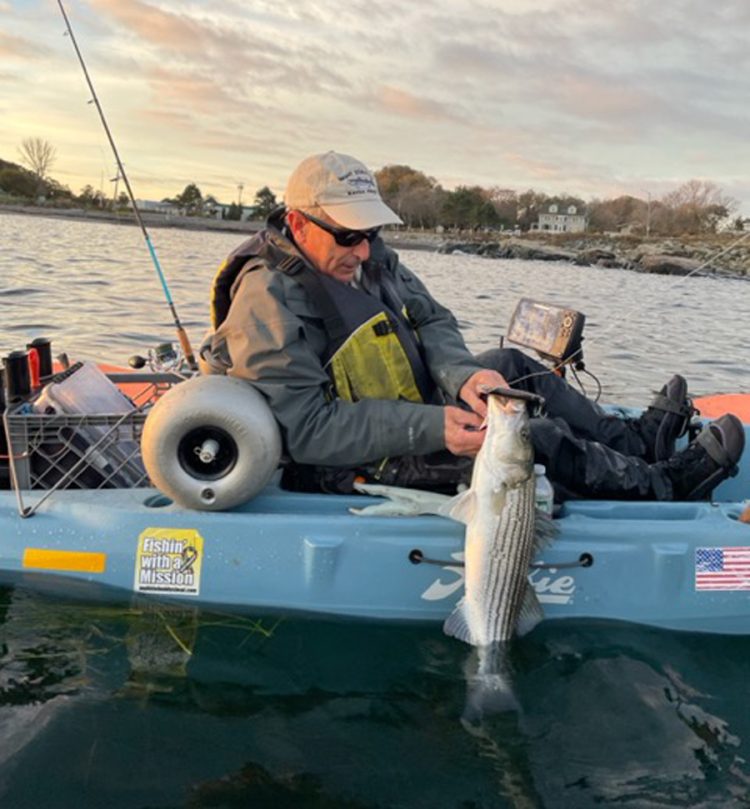 Marco Cicerano with kayak caught striped bass