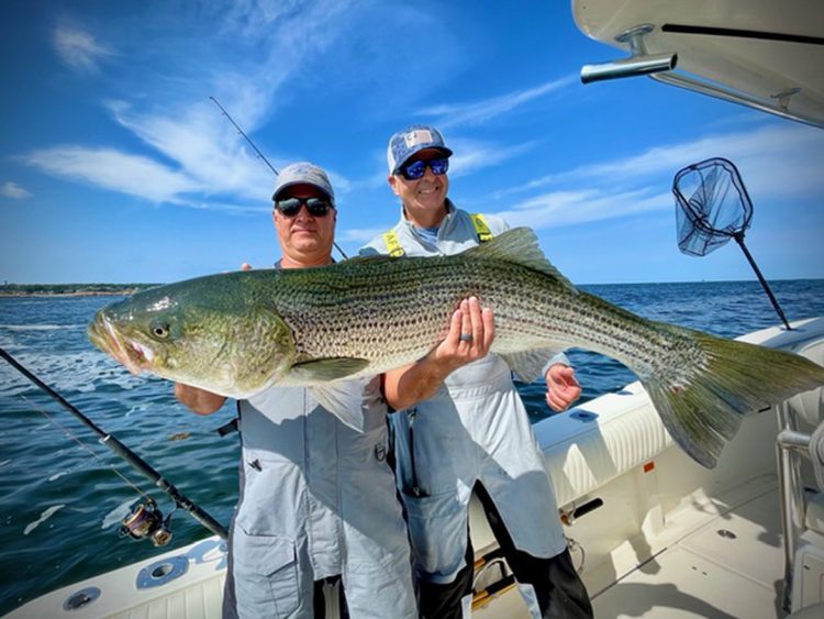 Shane Hawgleyand Captain Tom Ciulla with striper bass