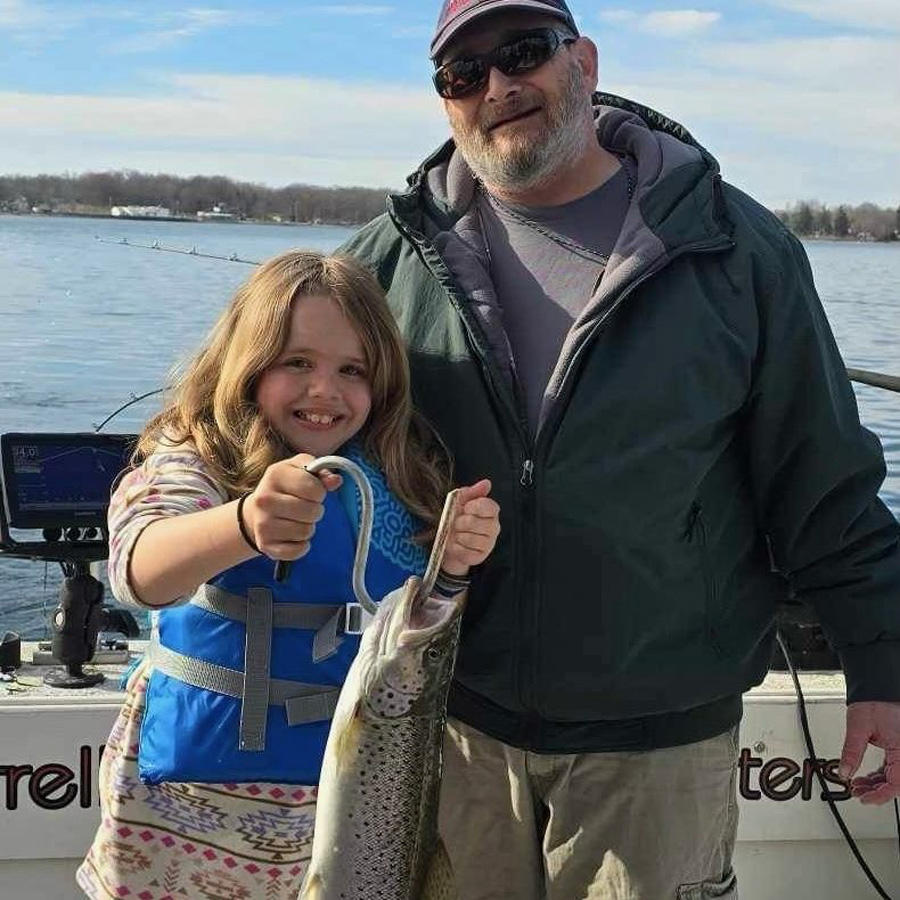 Chris L. and granddaughter with brown trout