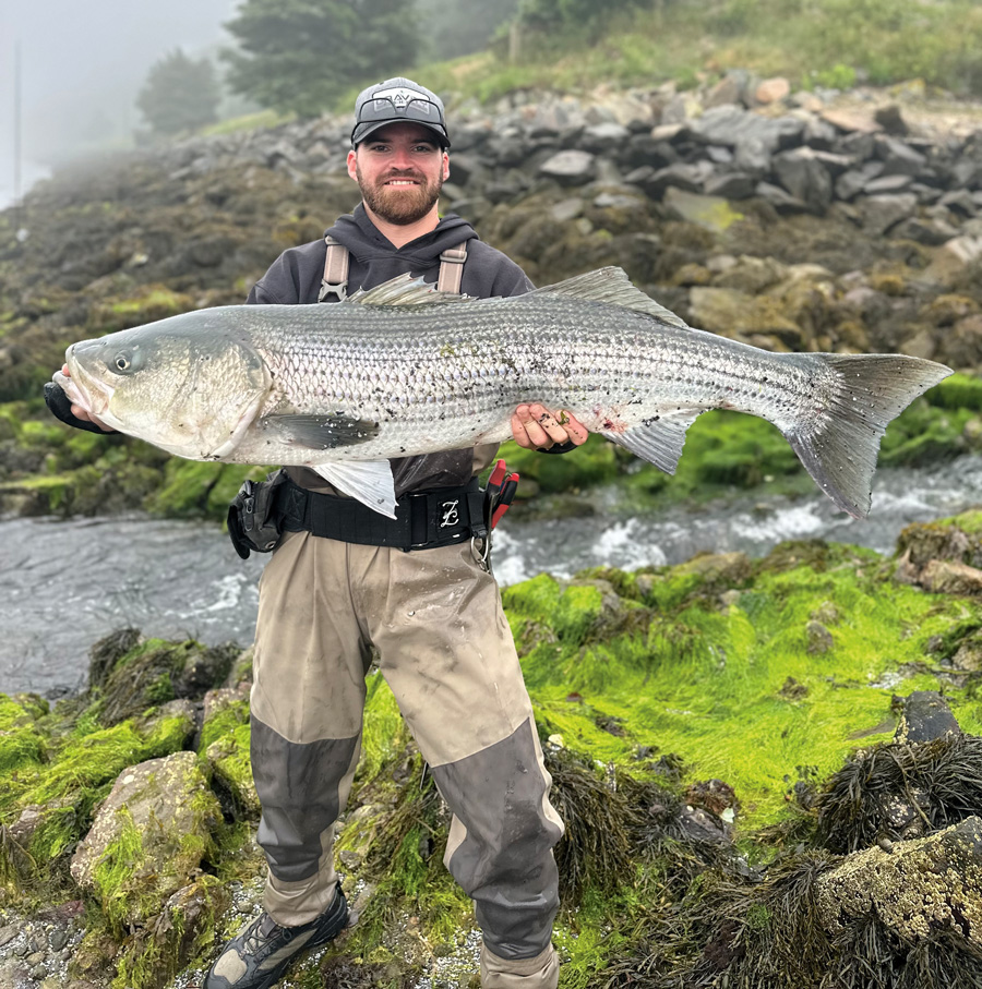 Derek Macnayr with Cape Cod Canal striped bass