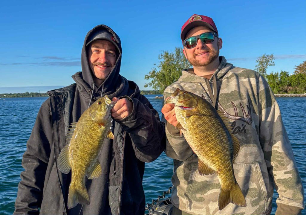 Capt. Tyler Siegmann of CGF Guide Service and Ryan Robina with pair of smallmouth bass