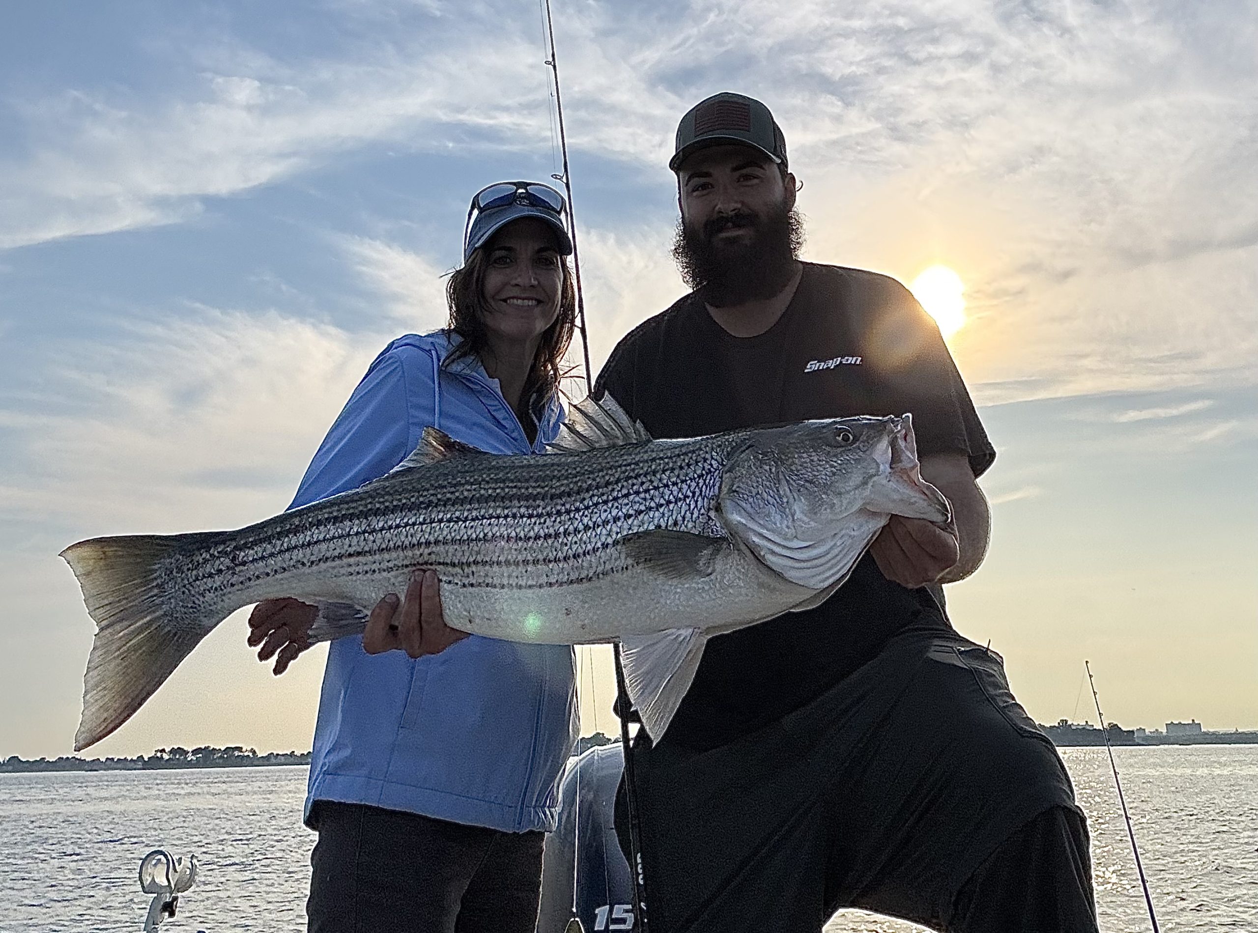 Andrew Bernat with a large striped bass caught by his mom Lisa in the Western Sound