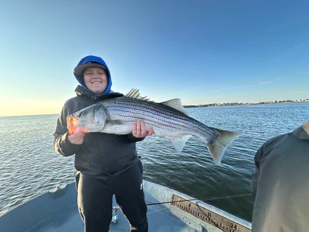 Keegan with his fist striped bass