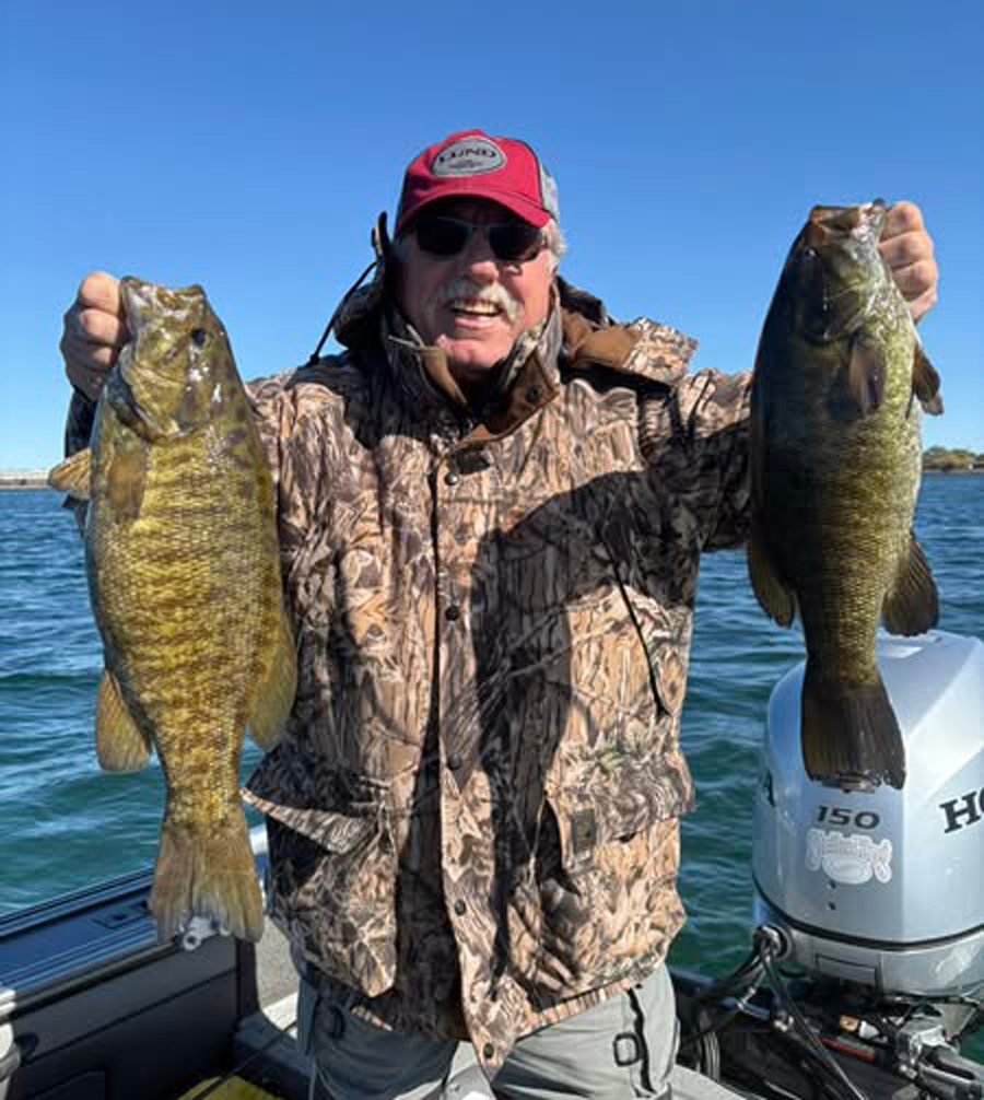 Carl Peroni with two smallmouth bass