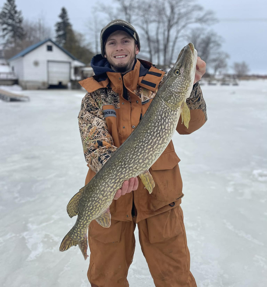 Nick LaRose with pike through the ice