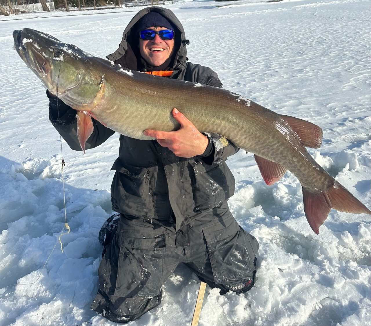 Victor Gelman holding his pending New Jersey state record muskellunge caught while ice fishing on Greenwood Lake
