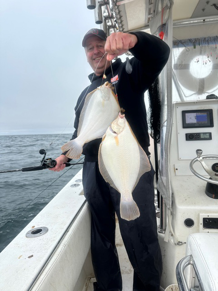 Jerry Nolan with pair of flounder aboard the Little Sister