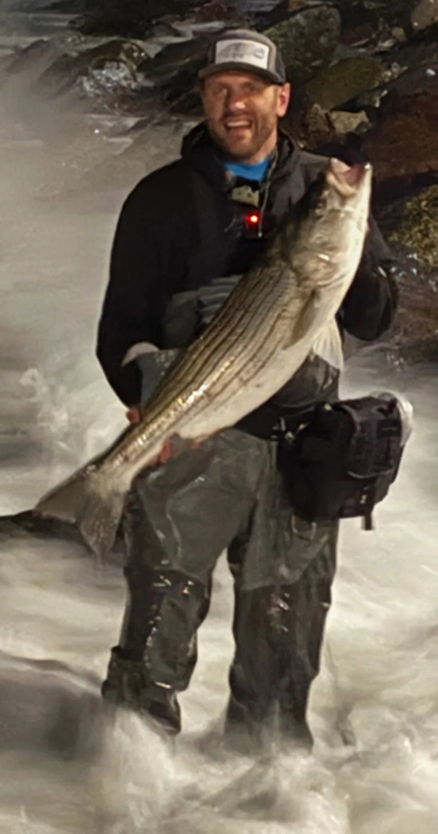 Marty Pino with striped bass in the surf