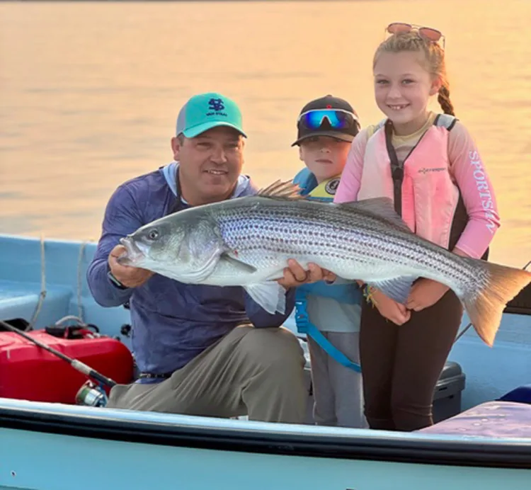 Tirado family with striped bass