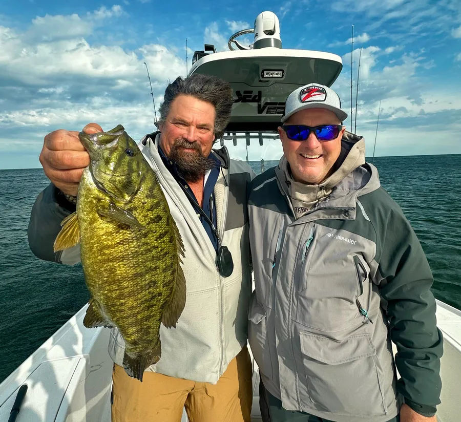 Carter Andrews and Capt. Frank Campbell with smallmouth bass