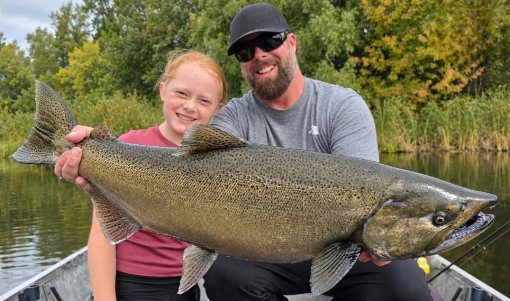 Braelyn and dad with big green king salmon