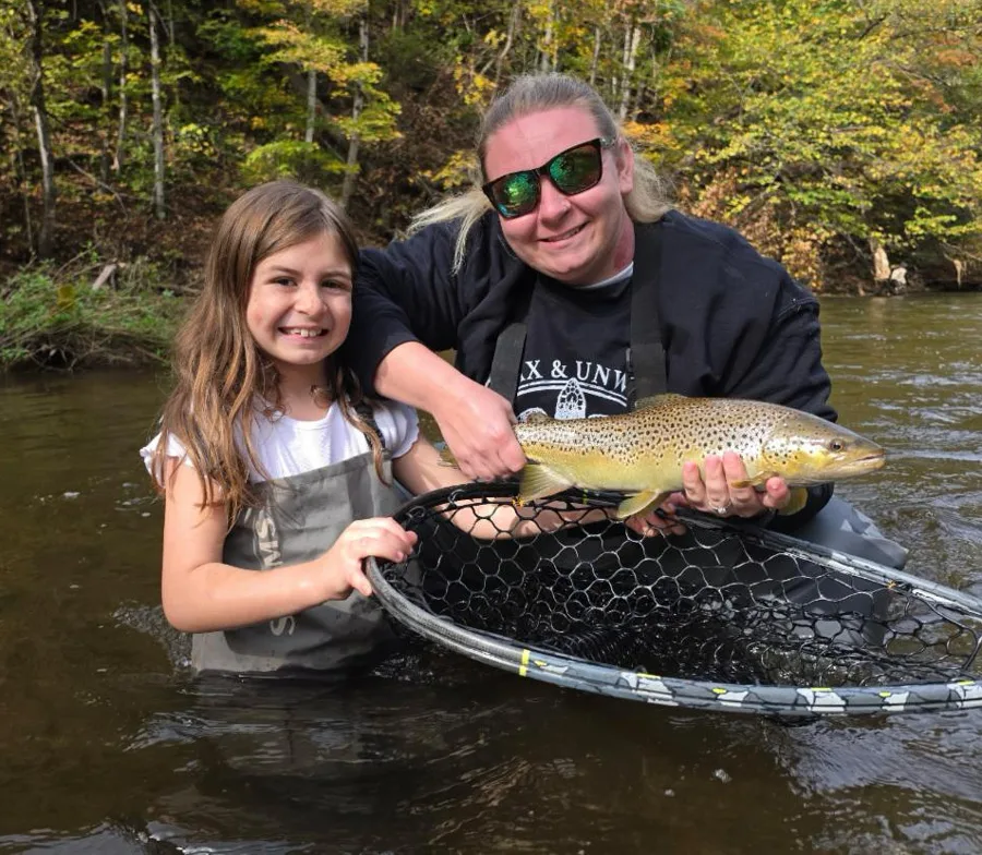 Morgan and daughter Myah with brown trout