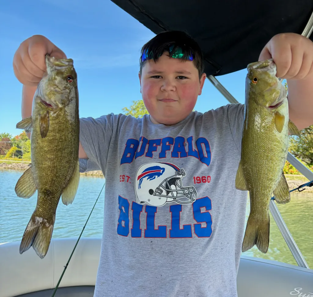 Parker Costello with pair of smallmouth bass
